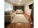 Living room with hardwood floors, a large rug, two sofas, and a TV at 1393 Bolton Nw Rd, Atlanta, GA 30331