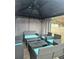 Covered patio area with a black metal gazebo, a couch, and chairs with blue cushions at 1393 Bolton Nw Rd, Atlanta, GA 30331
