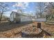 Exterior view of a one-story home with a fenced backyard, wooden deck, and a fire pit at 6214 Hagin St, Douglasville, GA 30134