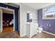 Bathroom with white vanity, toilet, and purple accent wall at 6214 Hagin St, Douglasville, GA 30134