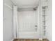Simple bathroom with shower/tub combo, white curtain, and built-in shelving at 6214 Hagin St, Douglasville, GA 30134