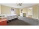 Cozy bedroom with carpeted floors, a ceiling fan, and ample natural light at 6214 Hagin St, Douglasville, GA 30134