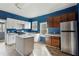 Kitchen with blue walls, white and brown cabinets, and an island at 6214 Hagin St, Douglasville, GA 30134