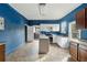 Kitchen with blue walls, white and brown cabinets, and an island with a gas stovetop at 6214 Hagin St, Douglasville, GA 30134