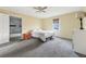 Large main bedroom featuring plush carpeting, a ceiling fan, and an attached bathroom at 6214 Hagin St, Douglasville, GA 30134