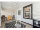Bright sunroom with tile flooring, ceiling fan, and access to the backyard at 6214 Hagin St, Douglasville, GA 30134