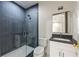 Bathroom with dark blue tiled shower, white vanity, and modern fixtures at 105 Nova Ln, Roswell, GA 30075