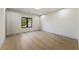 Empty bedroom with light hardwood floors and large window at 105 Nova Ln, Roswell, GA 30075