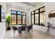 Dining room with large windows, modern light fixture, and stylish furniture at 105 Nova Ln, Roswell, GA 30075