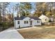 Charming white house with a concrete driveway and front yard at 1147 Graymont Sw Dr, Atlanta, GA 30310