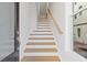 Staircase with wooden treads and white risers, leading to the upper level, with a window at 1332 Koa Se Ct # 100, Smyrna, GA 30080