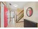 Welcoming foyer with a pink door, tiled flooring, and a staircase leading upstairs at 1769 Cord Ct, Tucker, GA 30084