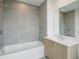 Modern bathroom with a soaking tub, contemporary fixtures, and tiled walls at 2425 Peachtree Ne Rd # 510, Atlanta, GA 30305