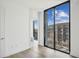 Bright bedroom with floor-to-ceiling windows, city views, and ensuite bathroom access at 2425 Peachtree Ne Rd # 510, Atlanta, GA 30305
