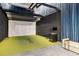 Indoor golf simulator room with putting green and seating area at 2425 Peachtree Ne Rd # 510, Atlanta, GA 30305