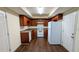 Clean kitchen with brown cabinets and white appliances, ready for meal preparation at 3793 Rainbow Dr, Decatur, GA 30034