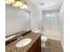 Clean bathroom with granite countertop, tiled shower, and modern fixtures at 2577 Ozella Sw Pl, Atlanta, GA 30331