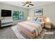 Virtually staged bedroom with a large bed, dresser, and window with natural light at 2577 Ozella Sw Pl, Atlanta, GA 30331