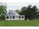 Quaint farmhouse featuring a green metal roof and spacious front lawn at 391 Rudy York Nw Rd, Cartersville, GA 30121