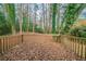 Wooden back deck surrounded by trees covered in lush, green ivy at 3930 Wedgefield Cir, Decatur, GA 30035