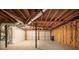 Unfinished basement with garage doors and exposed ceiling at 3930 Wedgefield Cir, Decatur, GA 30035
