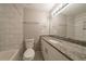 Spacious bathroom with vanity, toilet, and tiled walls at 3930 Wedgefield Cir, Decatur, GA 30035
