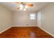 Large bedroom with polished hardwood floors, ceiling fan, and window at 3930 Wedgefield Cir, Decatur, GA 30035