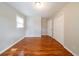Spacious bedroom with hardwood floors, a window, and closet at 3930 Wedgefield Cir, Decatur, GA 30035