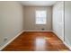 Empty bedroom featuring hardwood floors, closet, and window at 3930 Wedgefield Cir, Decatur, GA 30035