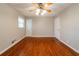 Large bedroom with hardwood floors, ceiling fan, and multiple doors at 3930 Wedgefield Cir, Decatur, GA 30035