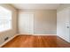 Empty bedroom with hardwood floors, a closet, and a window at 3930 Wedgefield Cir, Decatur, GA 30035