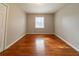 Empty bedroom with hardwood floors and a single window at 3930 Wedgefield Cir, Decatur, GA 30035
