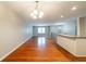 Open dining room with hardwood floors and a chandelier, adjacent to the kitchen at 3930 Wedgefield Cir, Decatur, GA 30035