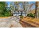 Charming two-story home with a driveway, front yard, and trees at 3930 Wedgefield Cir, Decatur, GA 30035