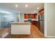 Modern kitchen with stainless steel appliances, wood cabinets, and an island with granite countertops at 3930 Wedgefield Cir, Decatur, GA 30035