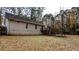 Backyard view of a two-story home with a wooden deck, surrounded by trees at 3419 Wesley Chapel Rd, Decatur, GA 30034