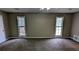 Large main bedroom with plush carpet, ceiling fan, and ample natural light at 3419 Wesley Chapel Rd, Decatur, GA 30034