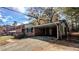 Carport and driveway leading to a two-story brick home at 578 Doyal Mills Ct, Stone Mountain, GA 30083