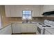 Bright kitchen featuring white cabinets, stainless steel appliances, and ample counter space at 578 Doyal Mills Ct, Stone Mountain, GA 30083