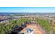 An aerial shot of a large home nestled among trees with a distant neighborhood view at 824 Braselton Hwy, Lawrenceville, GA 30043