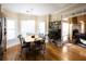 Dining room with hardwood floors, large window, and view to the living room at 907 Hannah Ct, Loganville, GA 30052