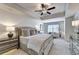 Spacious main bedroom with plush carpet, ceiling fan, and sitting area at 1611 Aiden Way # 53, Conyers, GA 30013