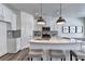 White kitchen with curved island, gray subway tile backsplash, and stainless steel appliances at 1611 Aiden Way # 53, Conyers, GA 30013