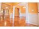 Dining area with hardwood floors, arched openings, white columns, and orange wall paint at 3680 Long Lake Dr, Douglasville, GA 30135