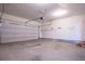 Spacious garage interior with garage door opener, storage shelves, and concrete floor at 3680 Long Lake Dr, Douglasville, GA 30135