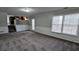 Inviting living room featuring ample carpeting, stairs, and adjacent to the kitchen at 798 Brownlee Ln, Lawrenceville, GA 30044