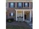 Inviting front porch with seating and charming brick exterior at 141 Mill Pond Xing # L5, Carrollton, GA 30116