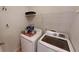 Laundry room with washer, dryer, and overhead shelving at 141 Mill Pond Xing # L5, Carrollton, GA 30116