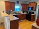 Kitchen featuring wood cabinetry, black appliances, and a breakfast bar at 2419 Centennial Hill Way Nw Nw Way, Acworth, GA 30102