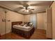 Bedroom with hardwood floors, ceiling fan, and closet with louvered doors at 750 Mount Vernon Hwy, Atlanta, GA 30327